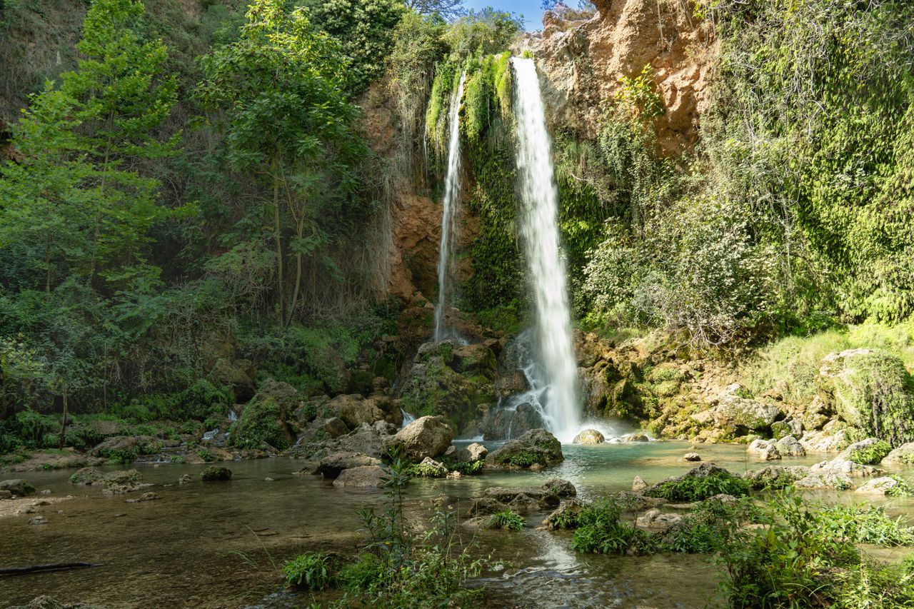 A stunning waterfall surrounded by lush greenery in Anna, Valencia.