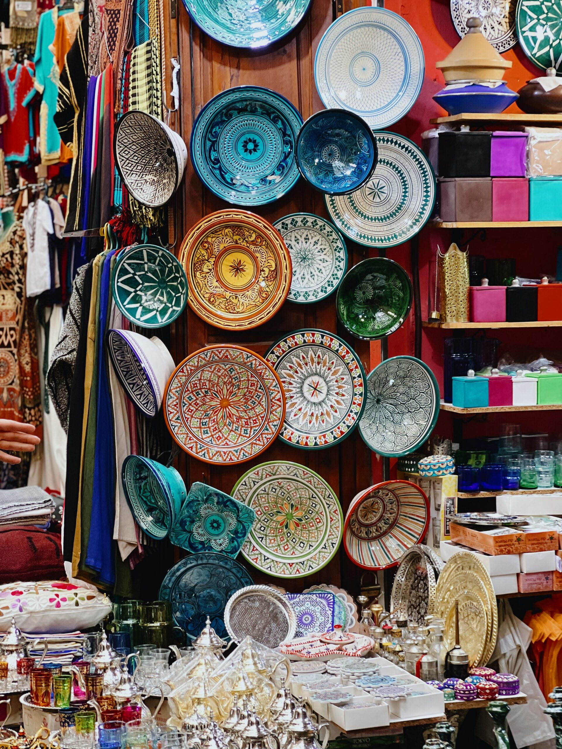 Colorful pottery and goods on display at Marrakech market in Morocco's medina.