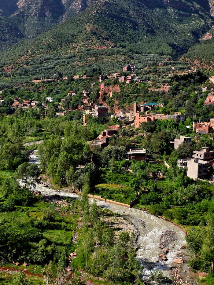 Stunning landscape of Ourika Valley with lush greenery and traditional buildings.