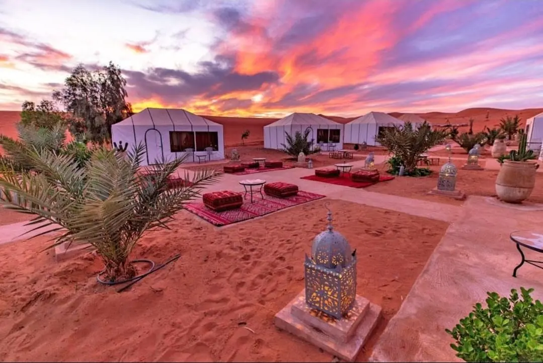 Luxury Sahara desert camp in Morocco at sunset